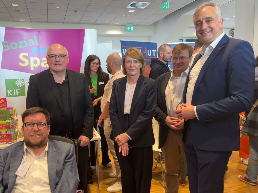 Frank Reinel (Inklusionsbeauftragter der Stadt Regensburg), Armin Wolf (Social Sponsoring Experte der KJF), Elke Büdenbinder (Juristin und Deutschlands First Lady), Michael Eibl (Direktor der KJF) und Dr. Thomas Burger (Oberbürgermeister der Stadt Regensburg) vor dem KJF-Stand.